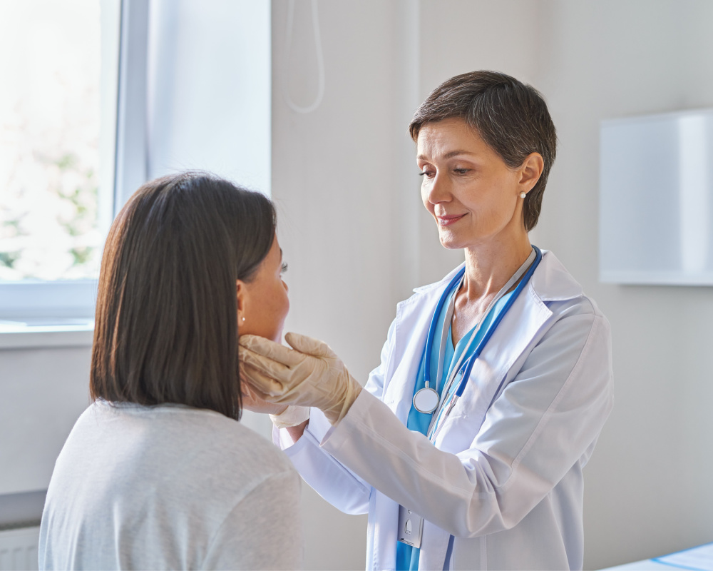 woman doctor wearing gloves checking sore throat